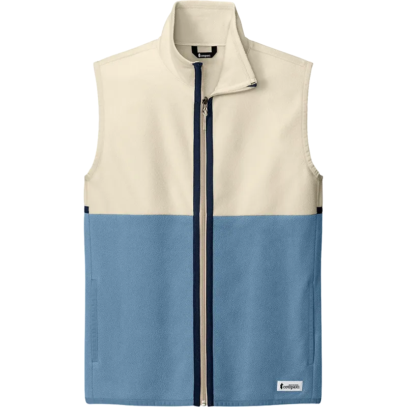 A color-blocked zip-up vest with a cream upper section and a slate blue lower section, featuring a dark navy zipper and a small white logo patch on the bottom right.