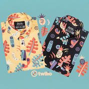 Two patterned shirts with colorful designs on a blue background, featuring the Twilio logo.