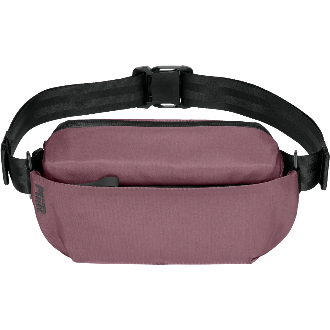 A dusty rose waterproof fanny pack with a black adjustable strap and buckle, shown against a plain white background.