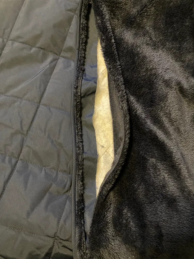 Eddie-Bauer_-Quilted-Insulated-Fleece-Blanket-embroidery-access-pocket-open.webp