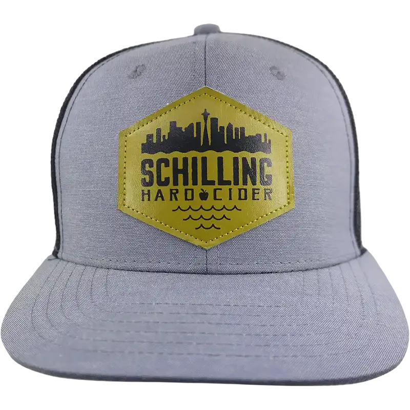 Gray cap with yellow and black Schilling Hard Cider logo on a white background