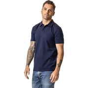 Man wearing a navy organic cotton polo shirt