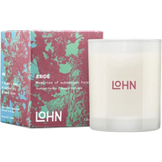 A frosted glass scented candle next to its colorful box. The candle is white with the brand name 'LOHN' printed in pink on the front.
