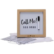 A square whiteboard-style sign with a light wood frame, printed with the words 'Call Me!' and a phone number, shown with a black marker and two sheets of alphabet cards on a white background.