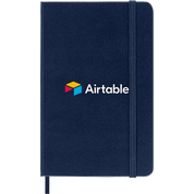 Navy Blue Moleskine Hard Cover Ruled Pocket Notebook featuring the Airtable logo, durable hard cover, elastic closure, ribbon bookmark, and rounded corners