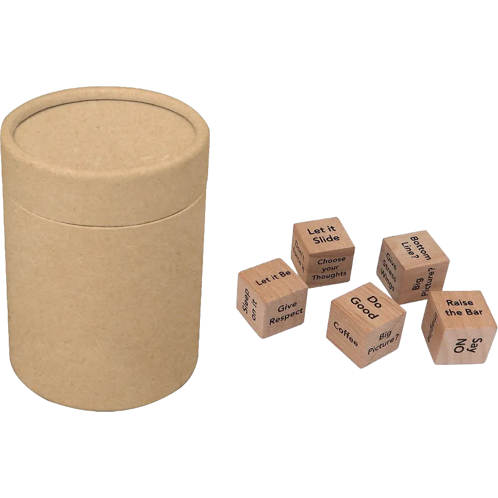 A round kraft paper storage cylinder with a lid next to five small wooden dice featuring printed phrases like 'Let it Slide', 'Give Respect', and 'Do Good' on a plain white background.