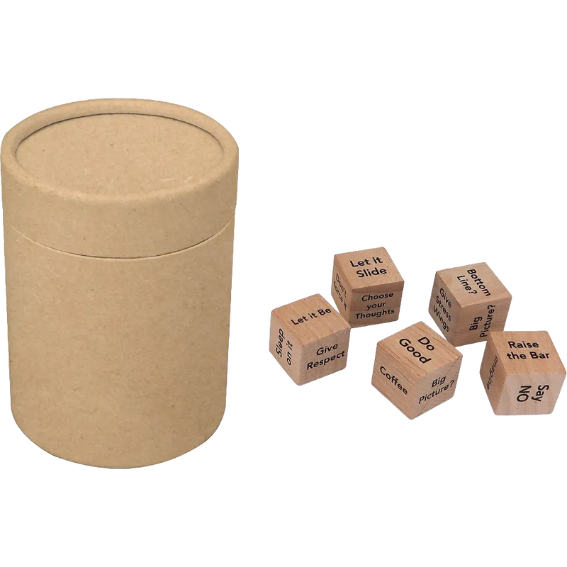 A round kraft paper storage cylinder with a lid next to five small wooden dice featuring printed phrases like 'Let it Slide', 'Give Respect', and 'Do Good' on a plain white background.