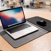 Laptop on a desk with a mouse and mouse pad 