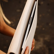 Person holding a white book 
