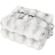 A folded white faux fur throw blanket with a light gray ribbon bow, shown on a solid white background.