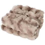 A folded faux fur throw blanket in a warm taupe-beige color, tied with a matching fabric ribbon and bow, on a solid white background.
