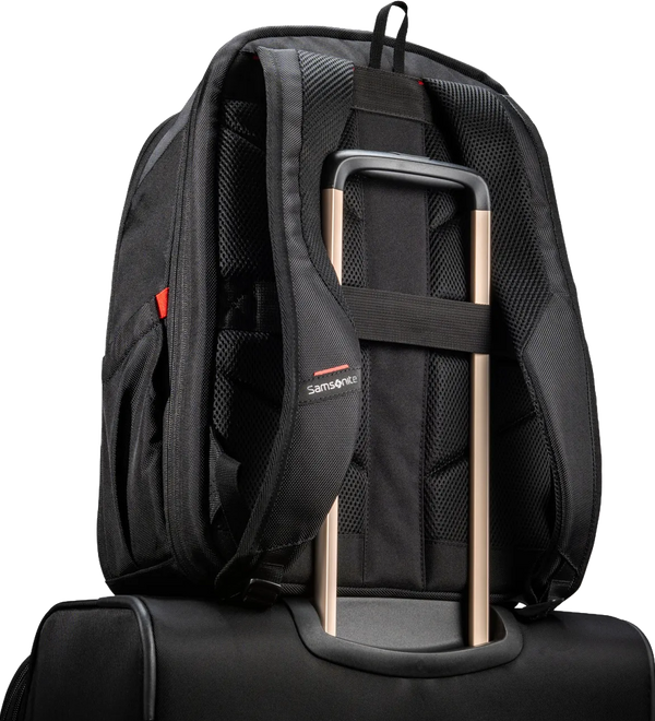 A black Samsonite backpack shown from the back, resting on top of a black rolling suitcase. The backpack features padded shoulder straps, a compression strap holding the suitcase handle, and a small red and white Samsonite logo on the side.