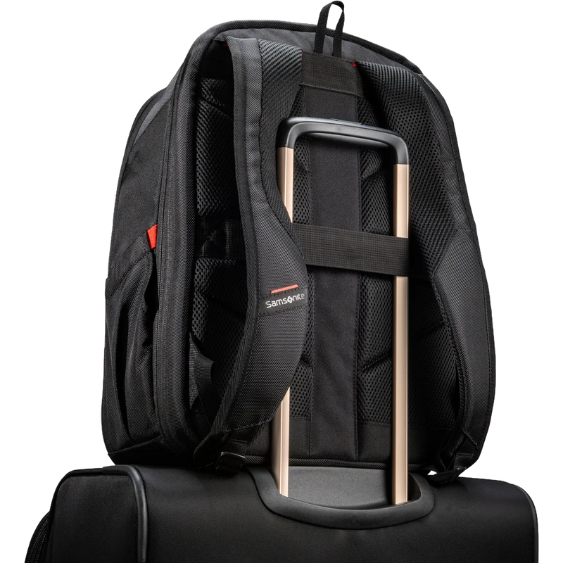 A black Samsonite backpack shown from the back, resting on top of a black rolling suitcase. The backpack features padded shoulder straps, a compression strap holding the suitcase handle, and a small red and white Samsonite logo on the side.