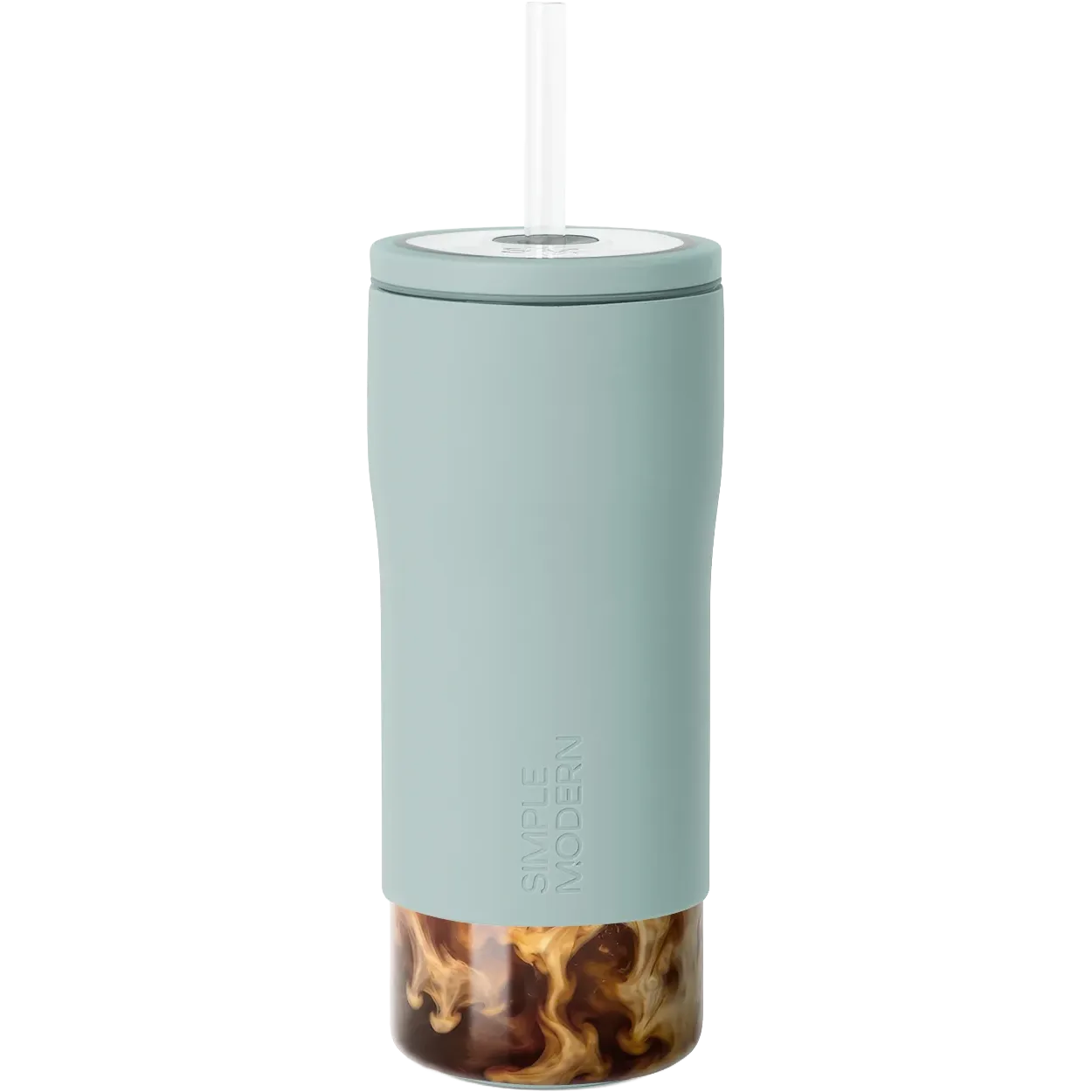 A tall, slim travel tumbler in a muted sage green color with a clear lid and straw, shown on a solid white background. The bottom portion of the tumbler is transparent, revealing a swirl of iced coffee inside.