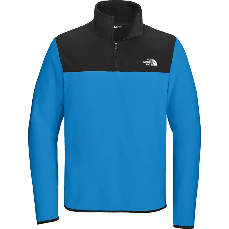 The North Face men's quarter-zip fleece pullover by The North Face, featuring a bright blue body and black yoke with a black collar, shown on a plain white background.