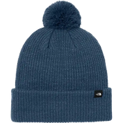 Blue knit beanie with pom-pom on a white background