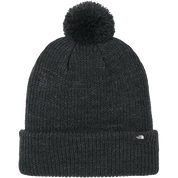 Black knit beanie with pom-pom on a white background