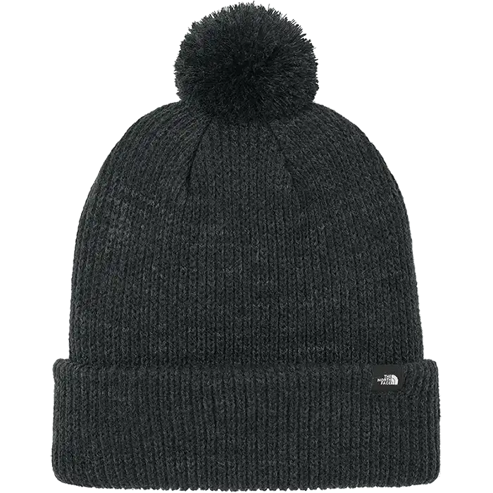 Black knit beanie with pom-pom on a white background