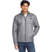 Model wearing The North Face ThermoBall Trekker insulated jacket in mid gray